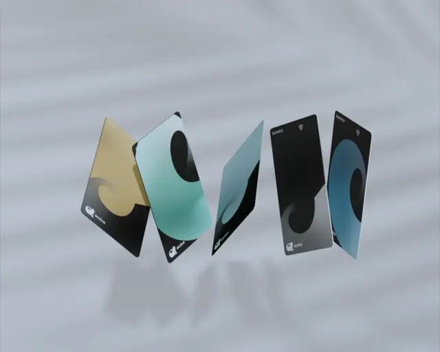 Five acba cards in gold, mint, teal, black and blue tumbling in a loose fan over grey cloth — 3D render
