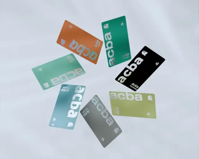 Seven acba ArCa cards in orange, green, black, olive, grey, blue and mint laid out in a circle on white